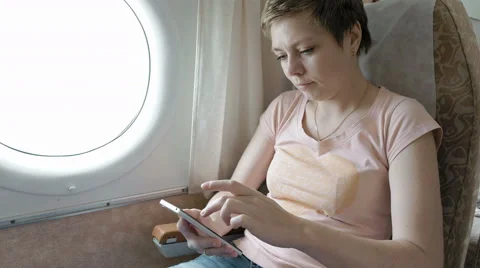 Airplane passenger scrolling through smart phone Stock Footage 65219716