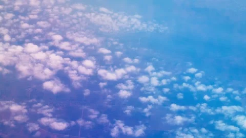 Airplane Passenger Window View of Altocumulus Clouds and Blue Sky Stock Footage 337228918