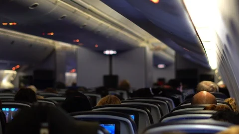Airplane passengers in flight being entertained in New York, USA Stock Footage 107941840