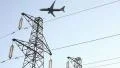 Airplane passing up the electrical towers HD Footage