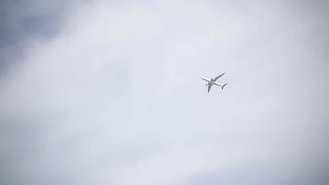 Airplane passing over Greenwich Stock Footage 166364321