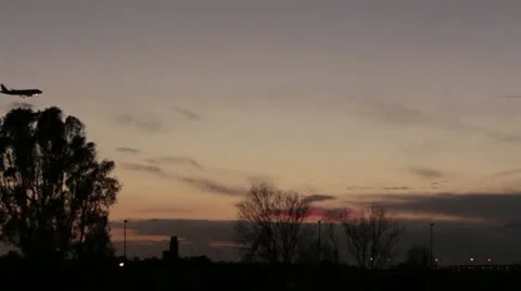 Airplane passing at sunset Stock Footage 20502616