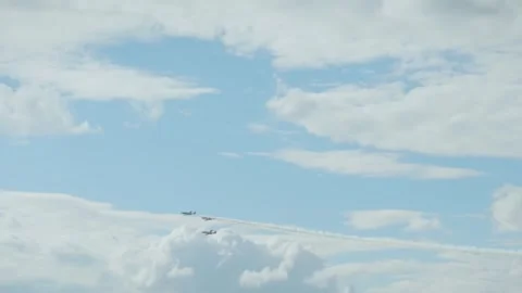 Airplane performing vertical dive with smoke trail in blue cloudy sky Stock Footage 340206314