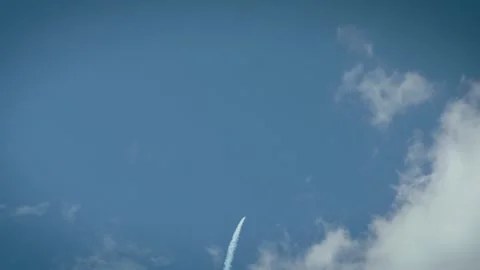 Airplane performing vertical dive with smoke trail in blue cloudy sky Stock Footage 340206404