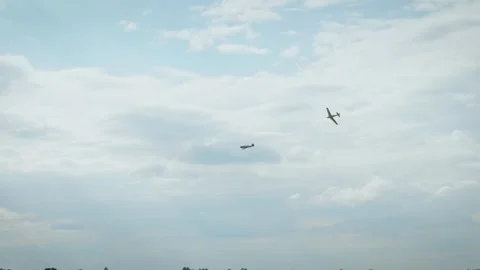 Airplane performing vertical dive with smoke trail in blue cloudy sky Stock Footage 340206512