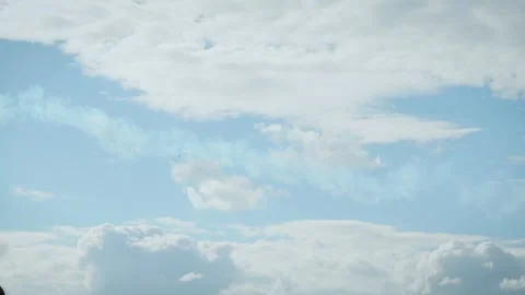 Airplane performing vertical dive with smoke trail in blue cloudy sky Stock Footage 340394407