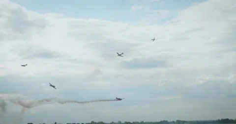 Airplane performing vertical dive with smoke trail in blue cloudy sky Stock Footage 340395038