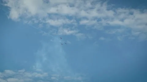 Airplane performing vertical dive with smoke trail in blue cloudy sky Stock Footage 340395213