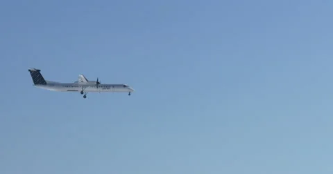 Airplane preparing for landing flying over frozen lake Ontario Stock Footage 47463021