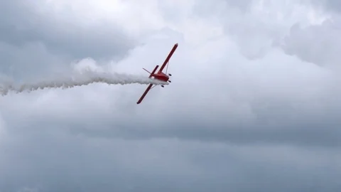 Airplane with rarefied smoke flow flies in the sky Stock Footage 80433553