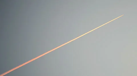 Airplane red path on blue sky, environment pollution, suset flight. Stock Footage 42935391