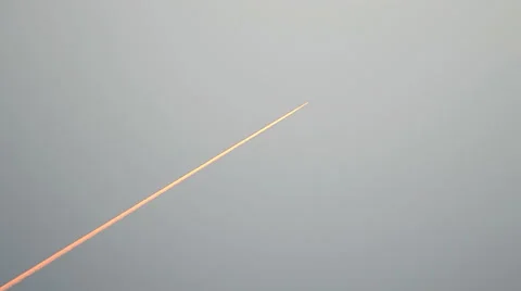 Airplane red path on blue sky, environment pollution, sunrise flight. Stock Footage 42935494