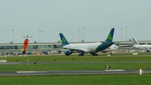 An airplane on a runway, with a windsock Stock Footage 259085287