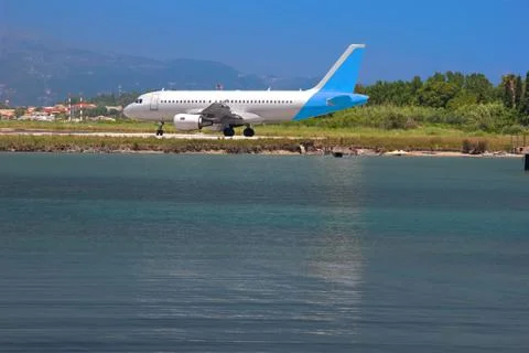Airplane on a seashore Stock Photos