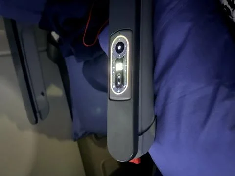 Airplane seat control panel with buttons and screen. Stock-Fotos