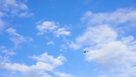 Airplane is seen take off over blue sky in evening 스톡 동영상 99177533