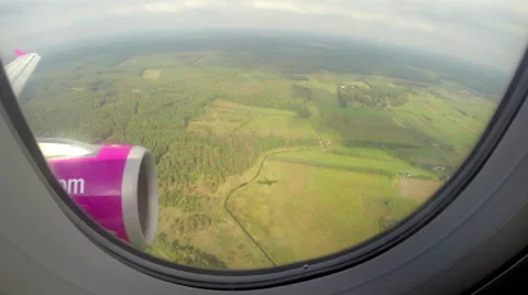 Airplane shadow on ground, descending plane passenger porthole, click for HD Stock Footage 43965550
