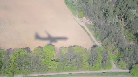 Airplane shadow on the ground during flying in sunny day, Stock Footage 64314556