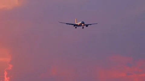Airplane with shining navigation lights flying in evening sky Stock Footage 73126509
