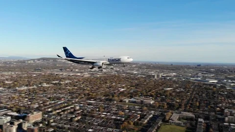 Airplane shot by a drone on the same altitude Flying over the city - airtransat 動画素材 121823024