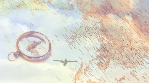 Airplane silhouette emerging from left flying behind compass across sepia map Stock Footage 314473164