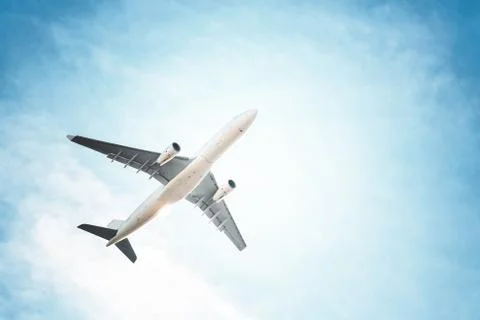 Airplane in the sky and clouds Stock Photos