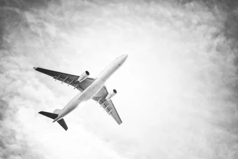 Airplane in the sky and clouds Stock Photos