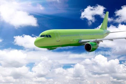 Airplane in a sky with clouds. Stock Photos