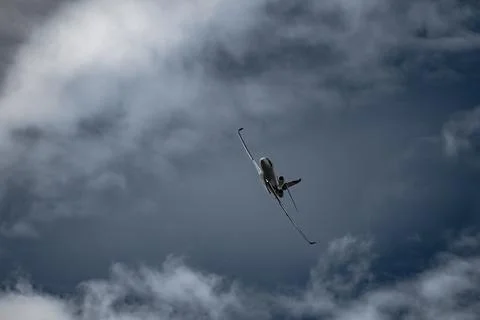 Airplane in the sky - cloudy day. Dramatic cloudy sky. Stock Photos