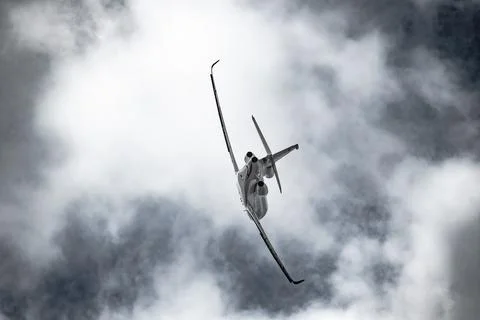Airplane in the sky - cloudy day. Dramatic cloudy sky. Stock Photos