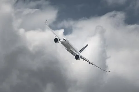 Airplane in the sky - cloudy day. Dramatic cloudy sky. 写真素材