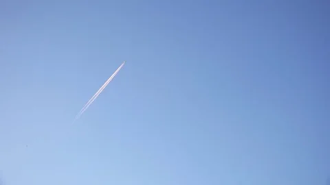 Airplane in the Sky with trail behind Stock Footage 77479281