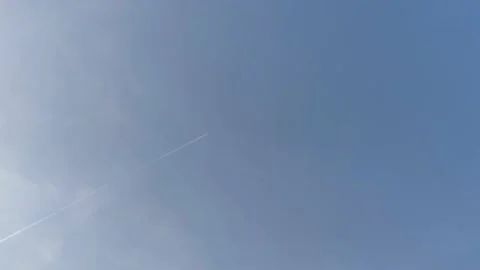 Airplane in the sky. White trace from the plane.  Stock Footage 197143943