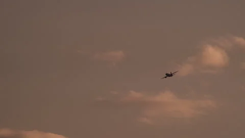 Airplane soaring in dusky sky Stock Footage 270062235