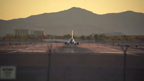 Airplane is speeding up and taking off from Harry Reid International Airport Stock Footage 273113124