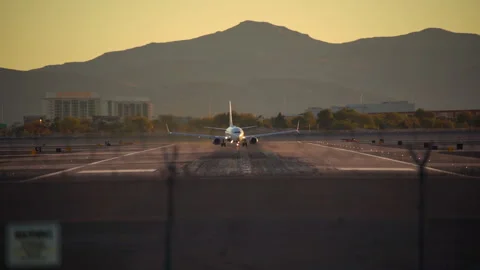 Airplane is speeding up and taking off from Harry Reid Airport in Las Vegas Stock Footage 273119351
