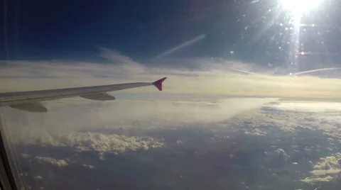 Airplane in stratosphere, maximum height clouds below sun flight Stock Footage 43964133