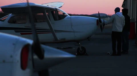 Airplane at Sunset, Man is Parking it Stock Footage 35583482
