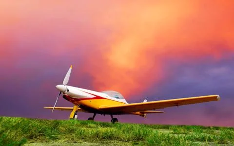 Airplane on sunset sky Stock Photos