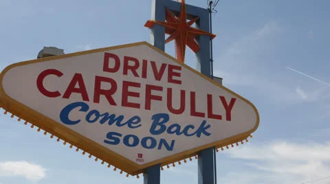 Airplane Take Off behind Welcome to Fabulous Las Vegas Nevada Sign, by day Stock Footage