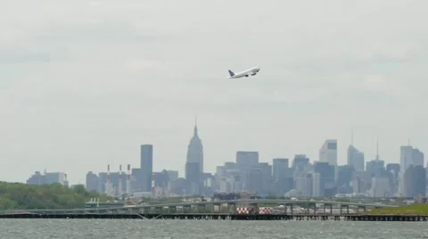 Airplane take off leaving LaGuardia Airport New York City Stock Footage