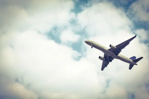 Airplane take-off from runways at cloudy sky. Color sepia Stock Photos