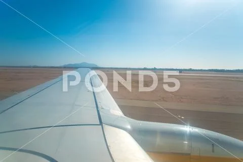 The airplane take off on the sunny background Stock Photos