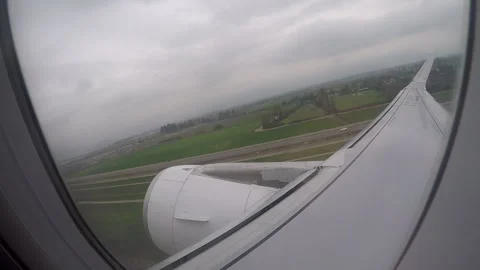 Airplane Takeoff View from Cabin Window on Cloudy Day Stock Footage 306780826