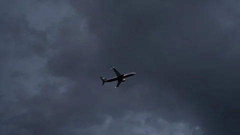 An Airplane Takes Off in a Cloudy Sky Stockbeeldmateriaal 75207017