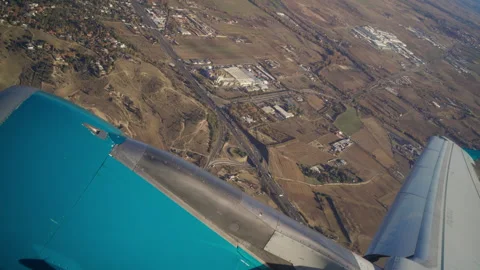 Airplane taking off above landscape Stock Footage 322960967