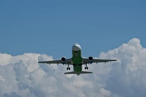 Airplane taking off against clouds Stock Photos