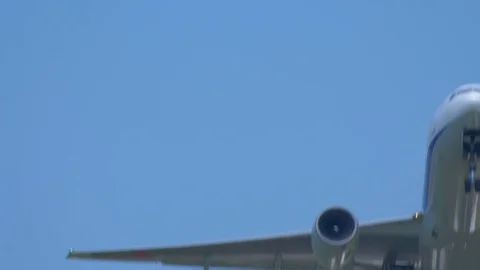 Airplane taking off in blue sky, extremely closeup Video stock 79011231
