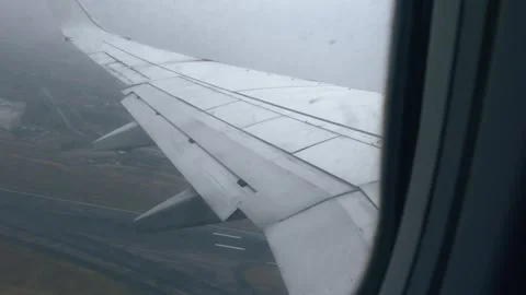 Airplane taking off into clouds wing view Stock-Footage 333619084