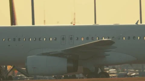 Airplane taking off during sunset at the airport in the evening hours with clear Stock Footage 335545642